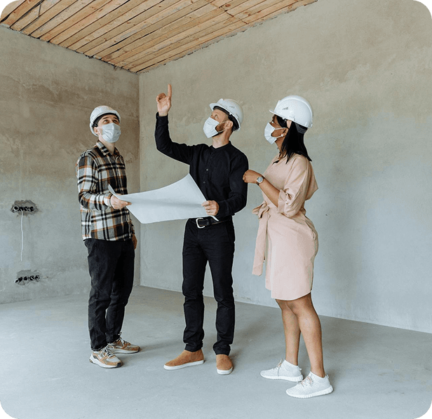 Construction professionals reviewing blueprints on site